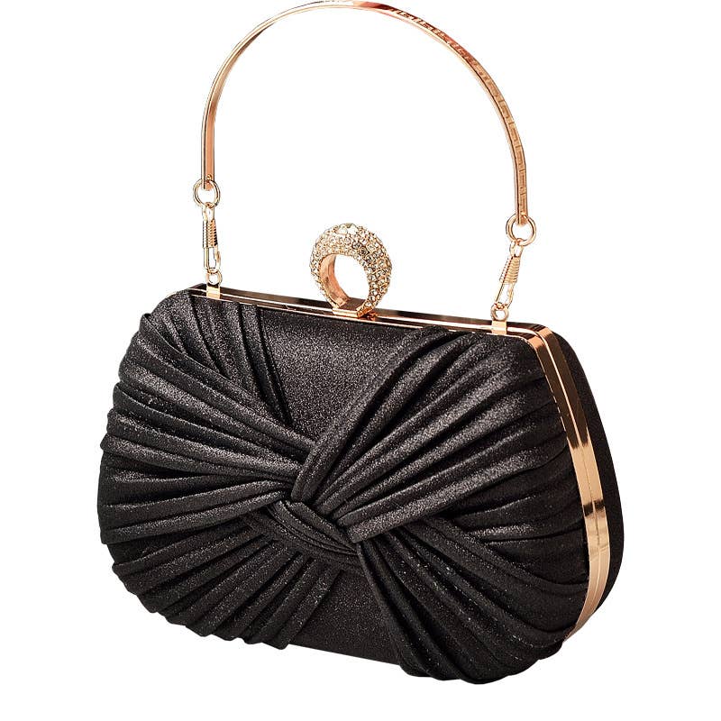 Black clutch bag with gold handle and diamante clasp on a white background